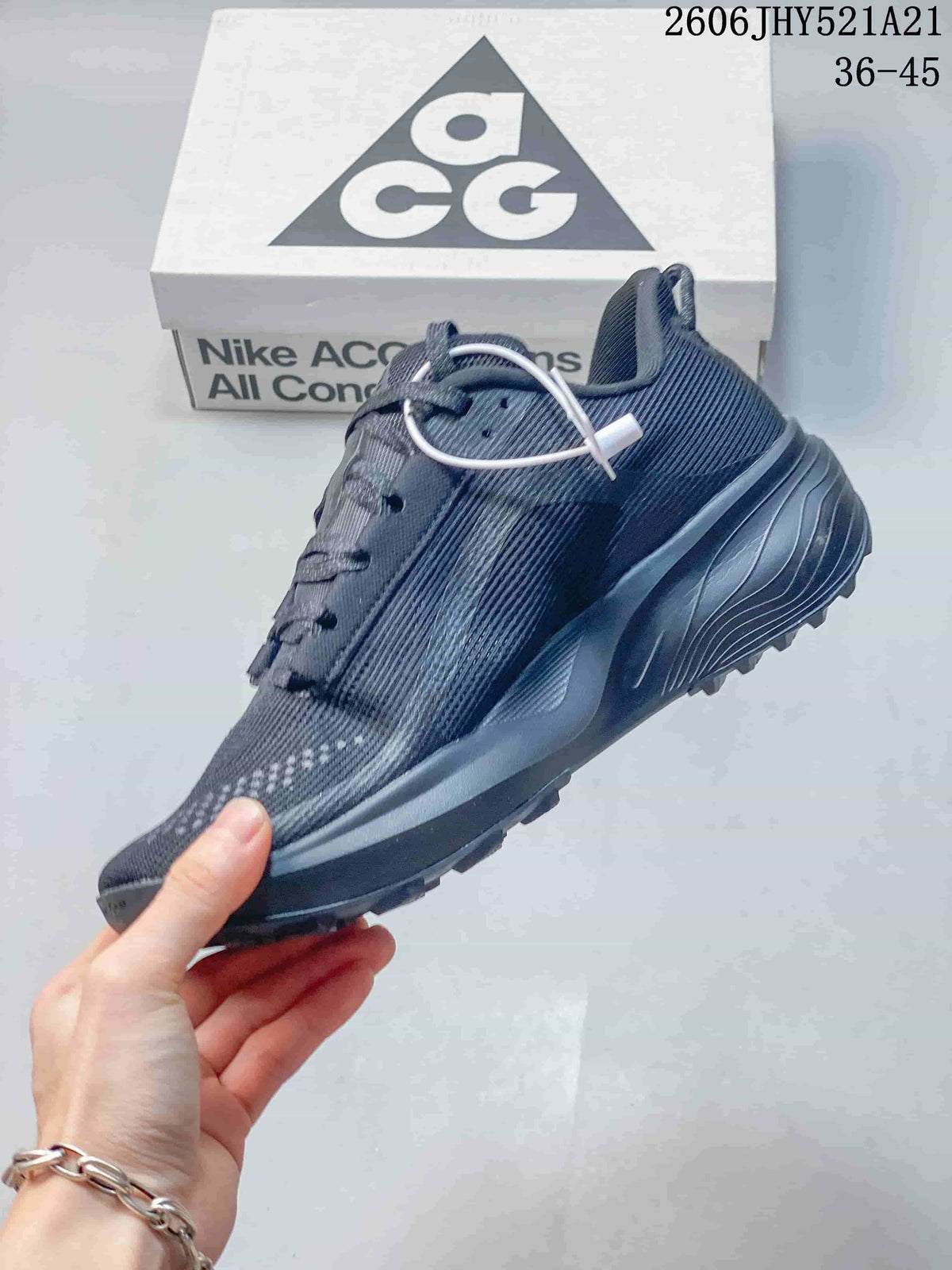 Side view of a dark gray Nike ACG shoe with a mesh-look upper and sculpted sole.
