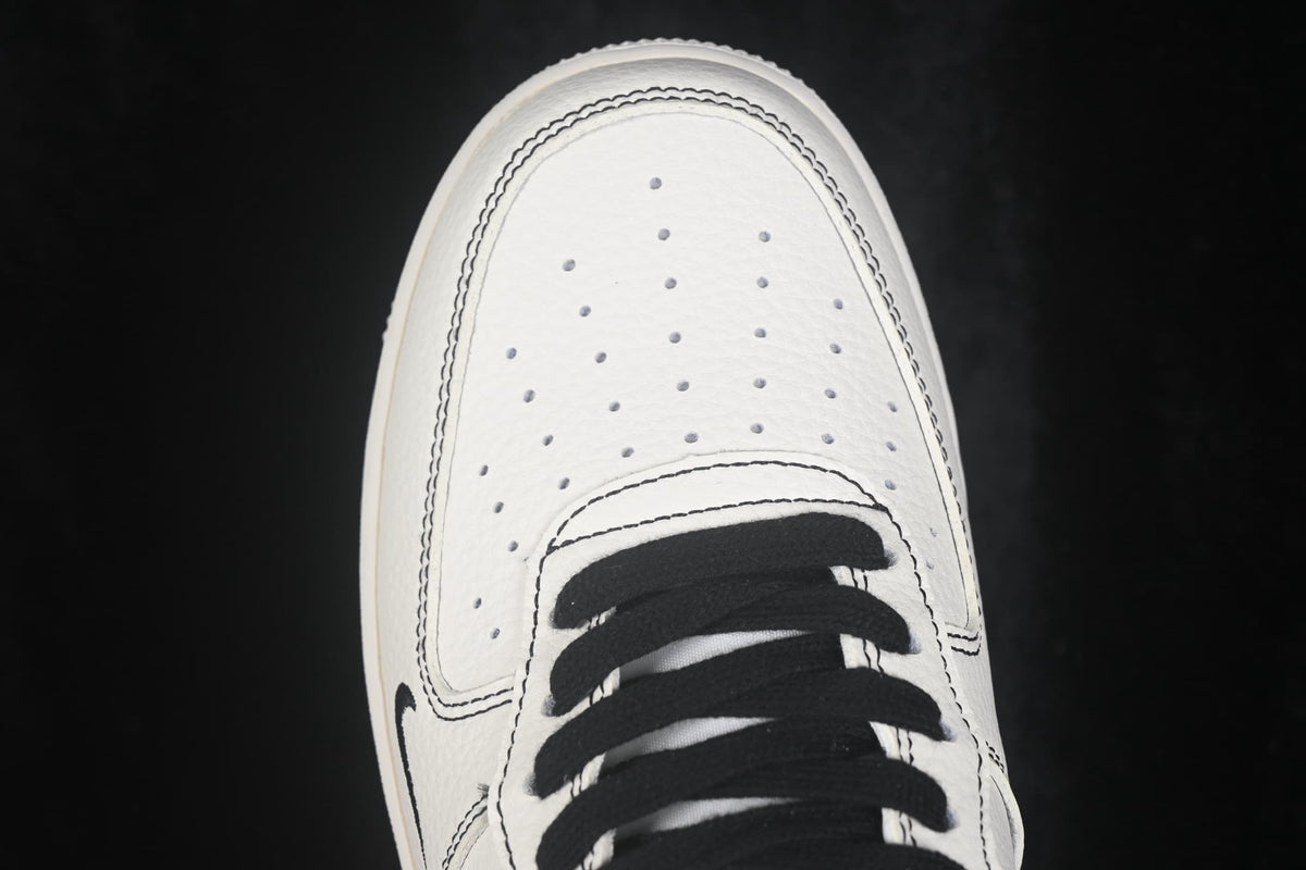 Close-up of the perforated white toe panel and black laces.