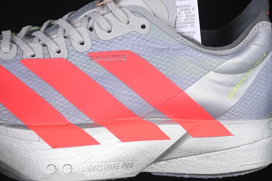 Close-up of coral stripes, patterned upper and Lightstrike Pro midsole marking
