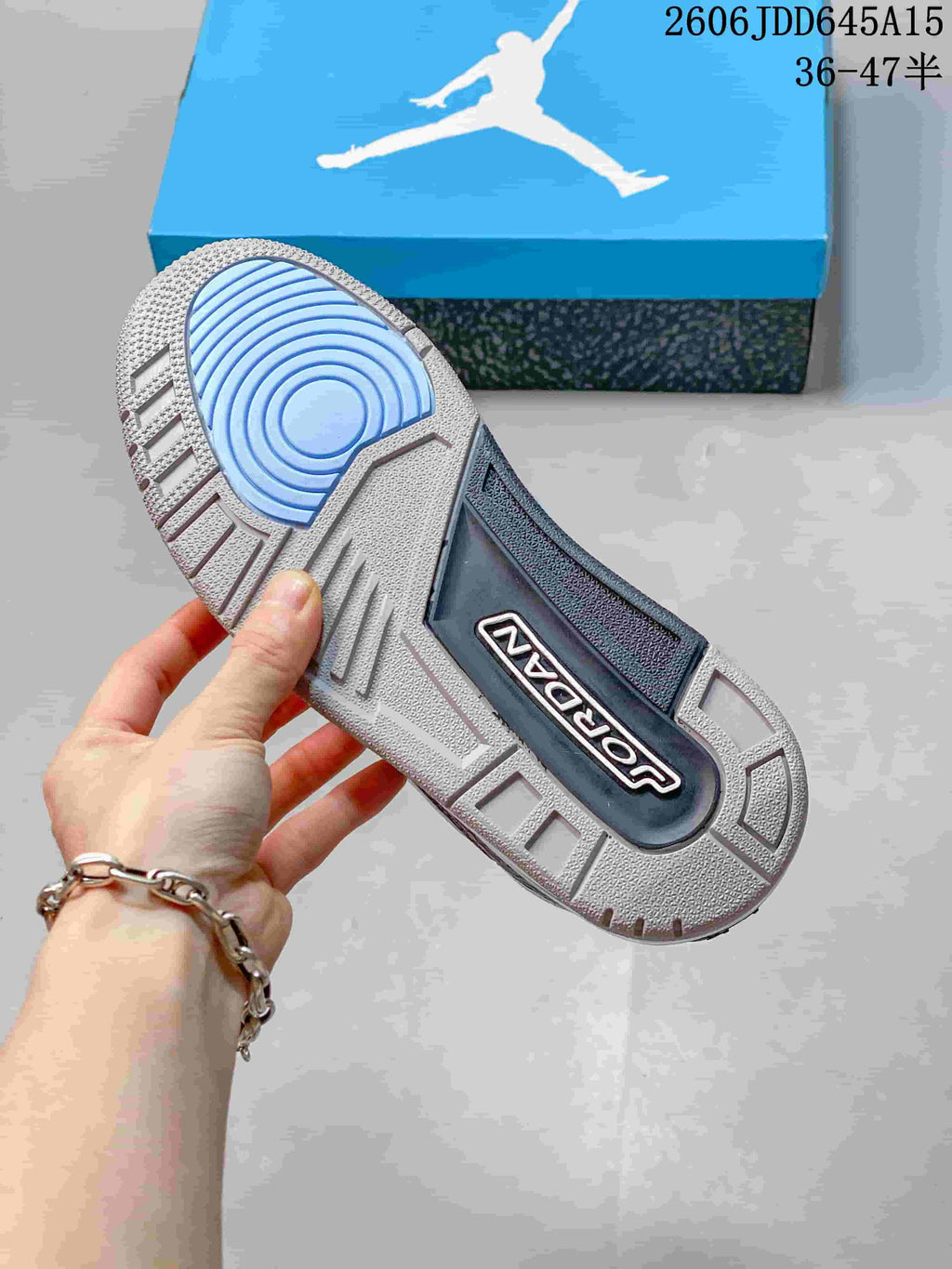 Outsole view showing circular blue traction detail and Jordan branding.