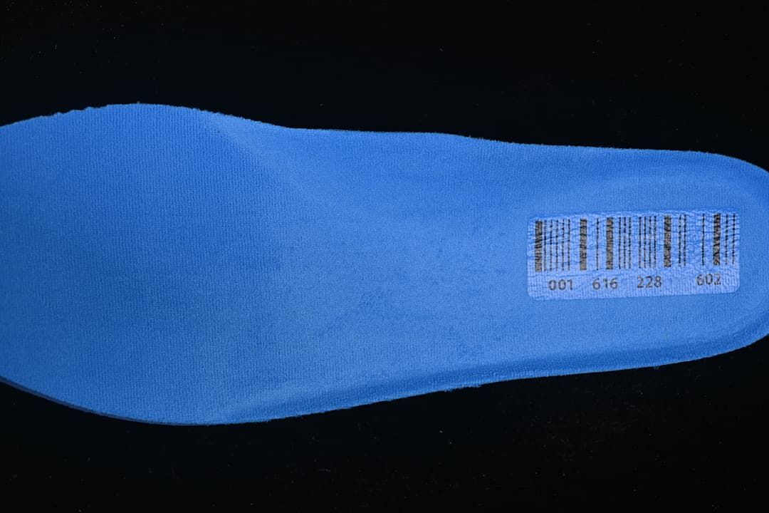 Reverse side of the blue insole with a small barcode label