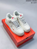 Pair of white and off-white Nike Air Force 1 low-top sneakers on a red box