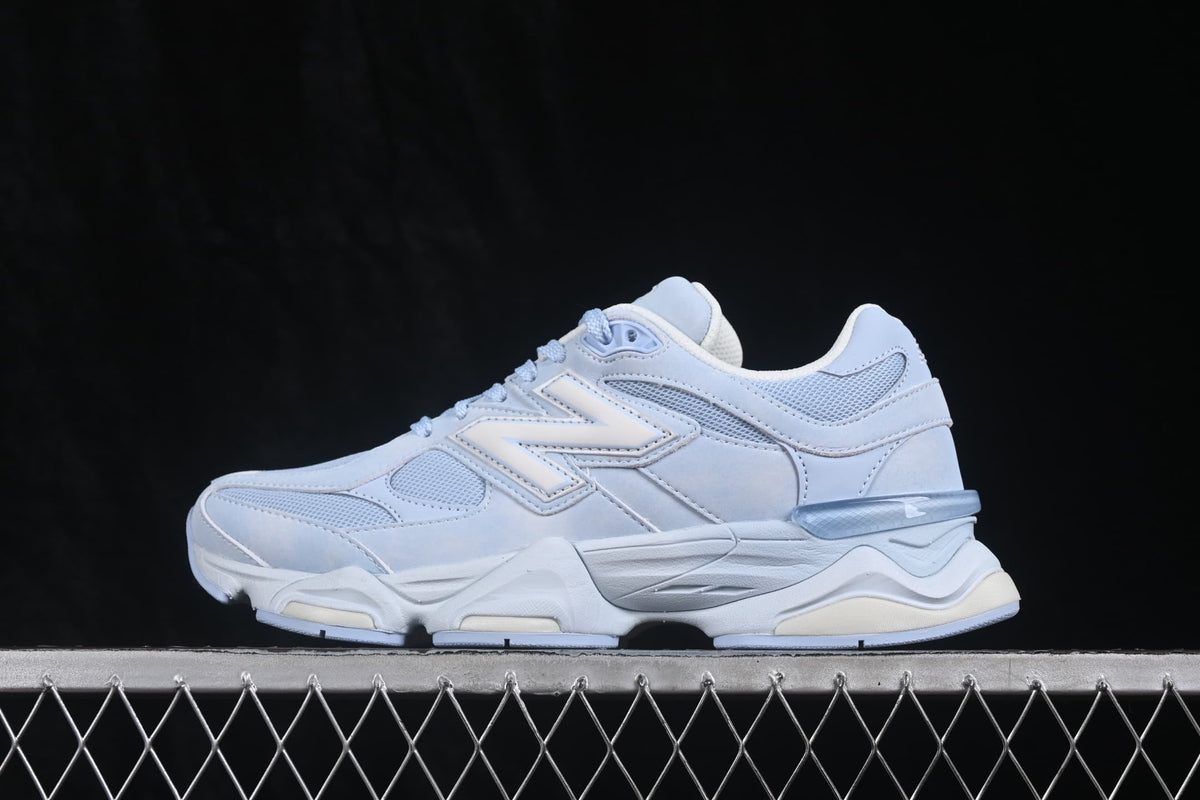 Side profile highlighting the New Balance logo, mesh panels, overlays, and translucent heel detail.