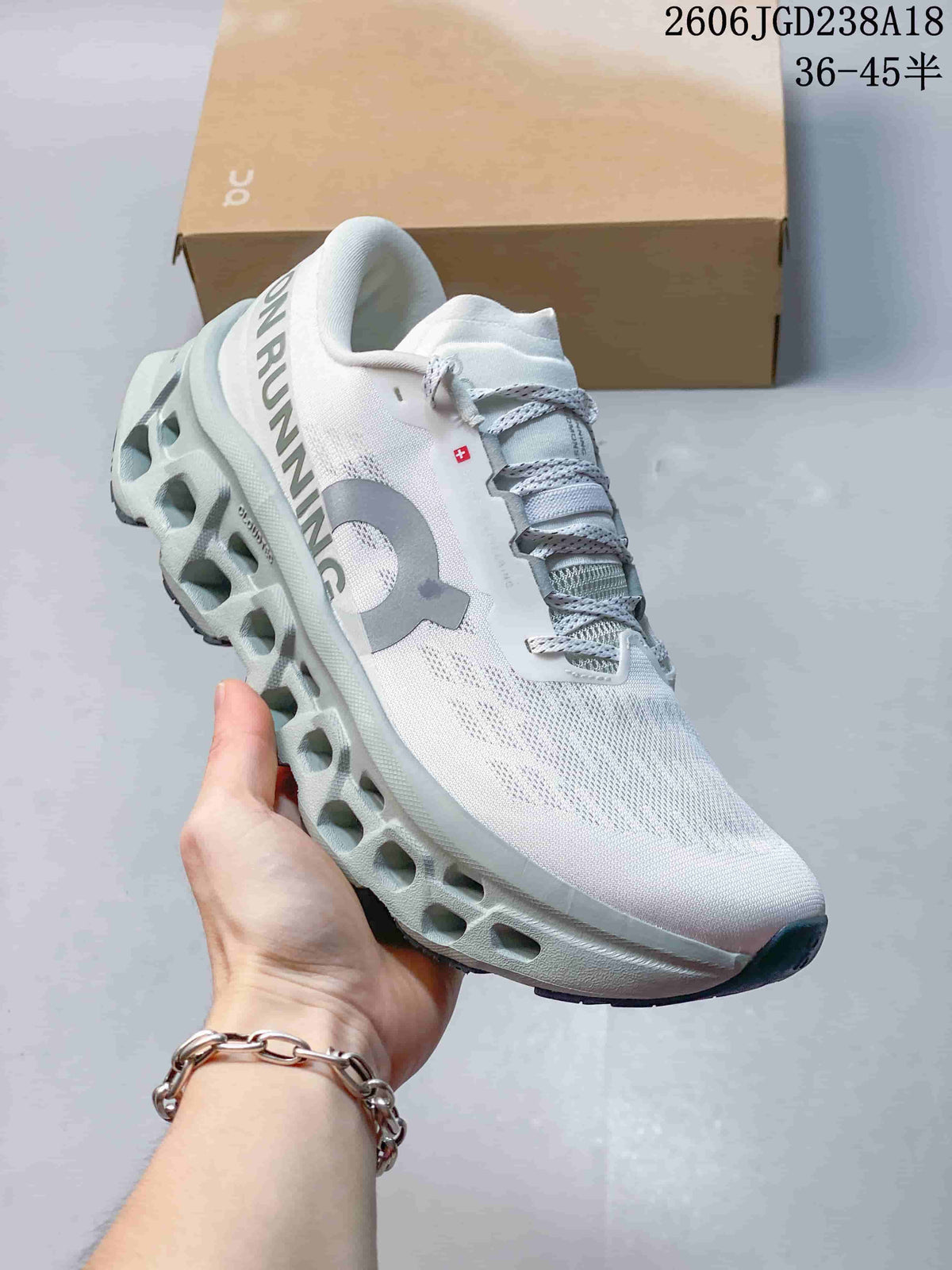 Angled side view of the white On Cloudmonster sneaker