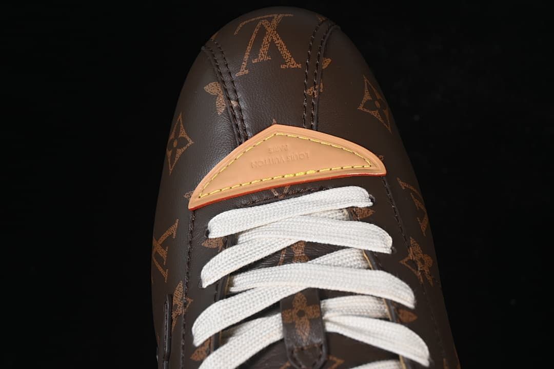 Top view of the toe area, tan trim, and cream laces.