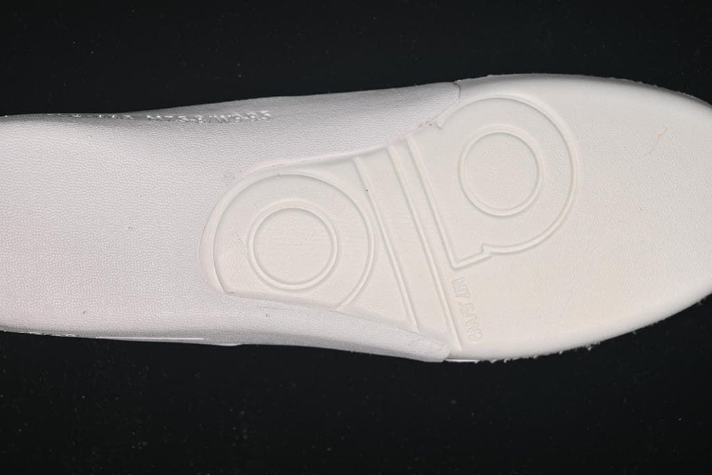 Close-up of the sneaker outsole with embossed Alo branding
