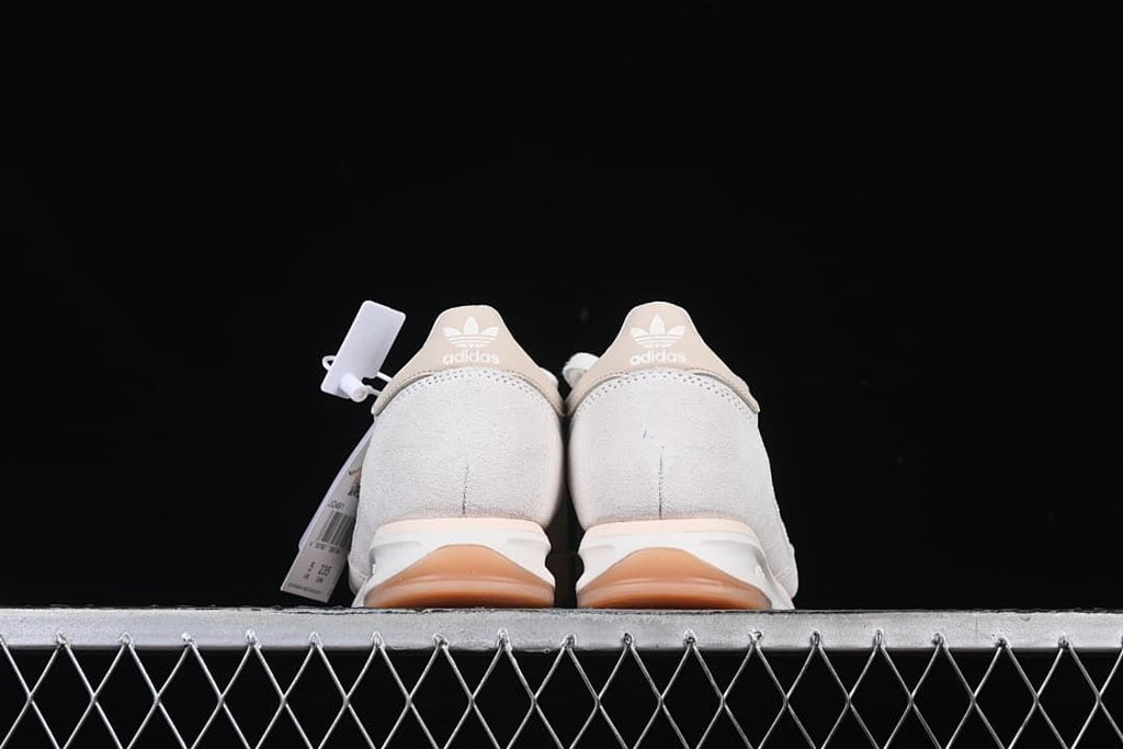 Rear view of both shoes showing beige heel tabs