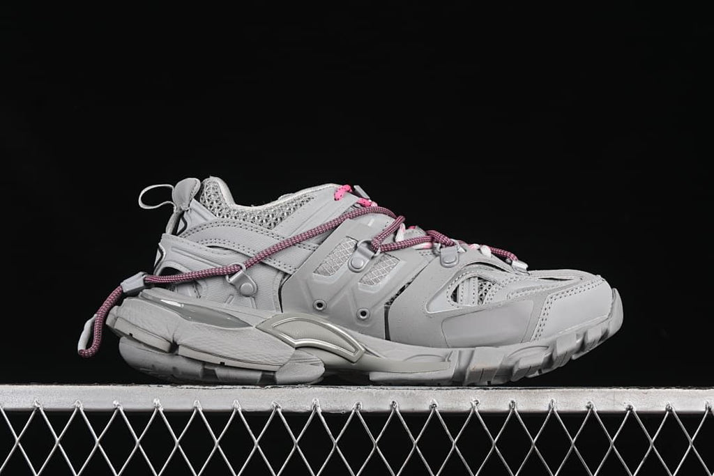 Side profile of the grey sneaker showing its layered design and cord laces