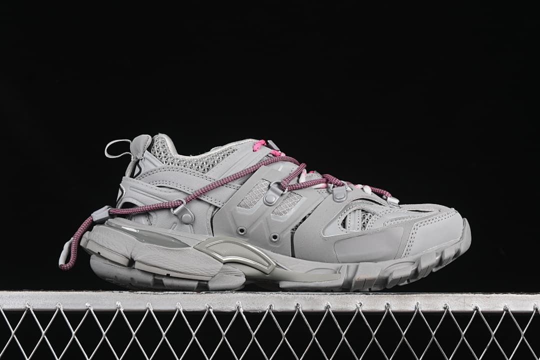 Side profile of the grey sneaker showing its layered design and cord laces