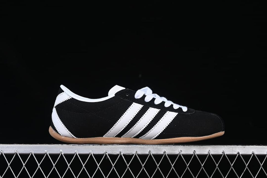 Side profile of the sneaker showing stripes and gum-colored sole