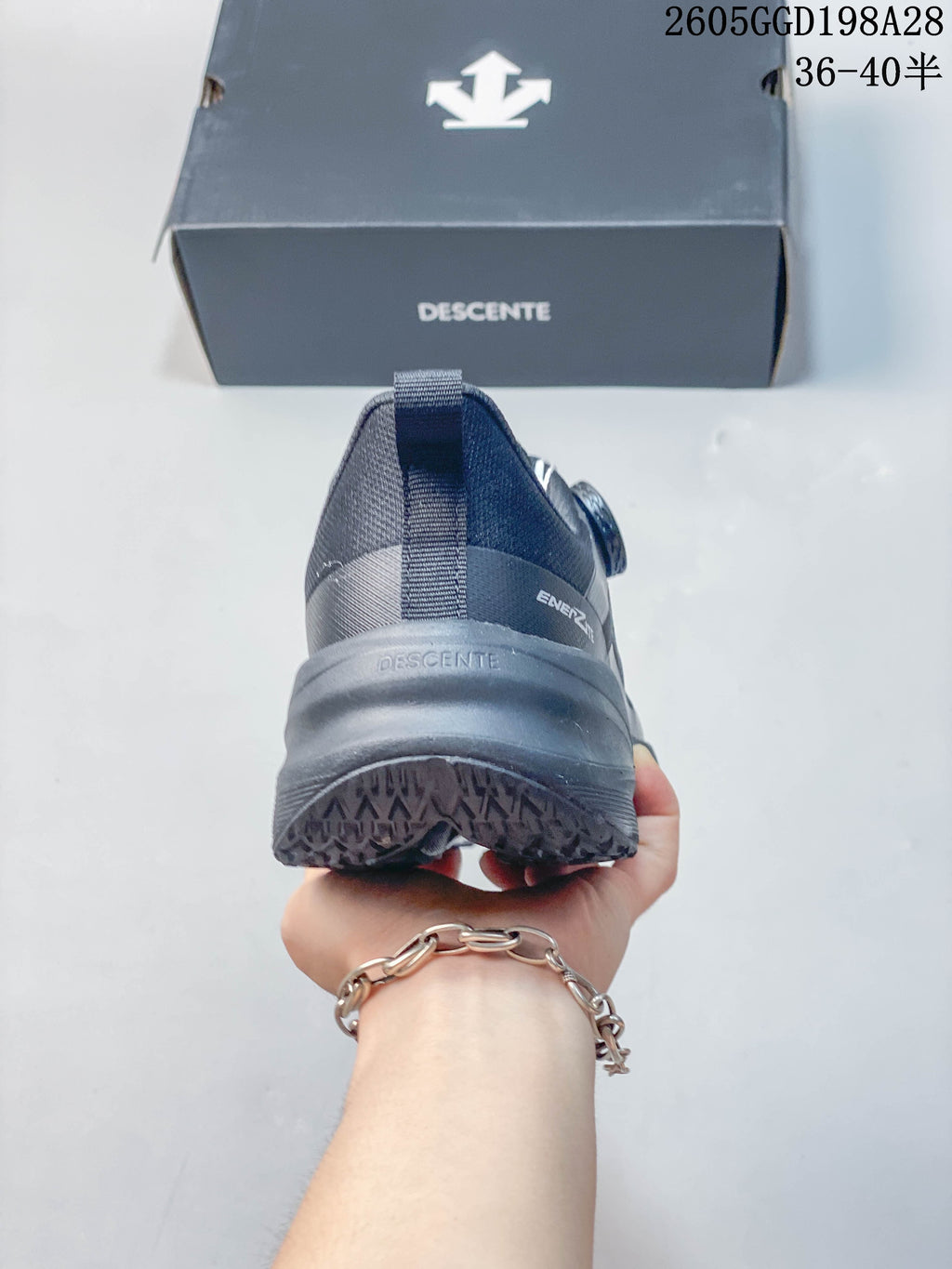 Rear view of a gray DESCENTE running shoe
