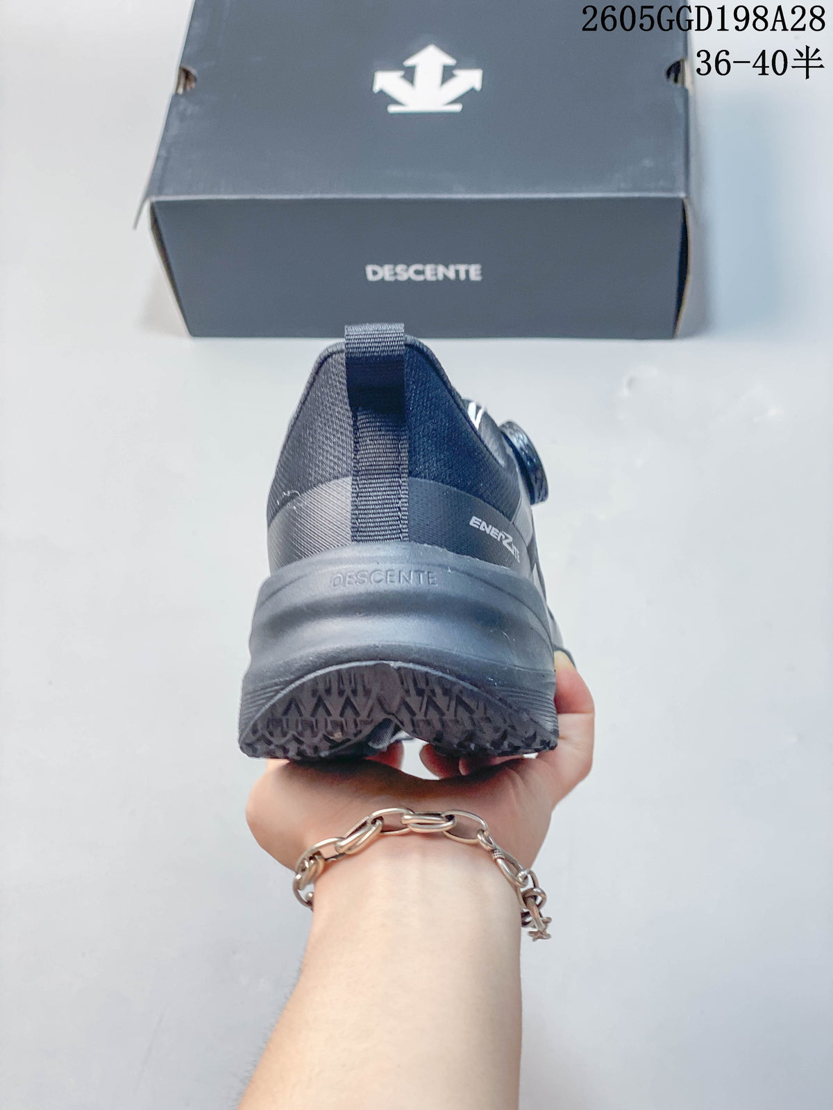 Rear view of a gray DESCENTE running shoe