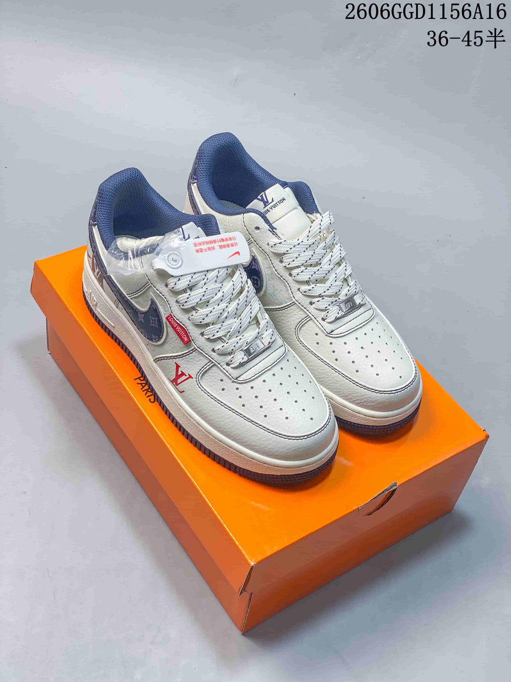 Pair of off-white low-top sneakers with navy patterned accents and navy soles