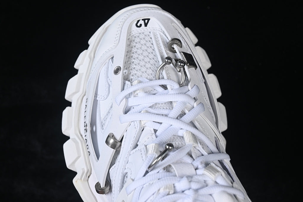 Top-down close-up of the laces and metal-tone hardware.
