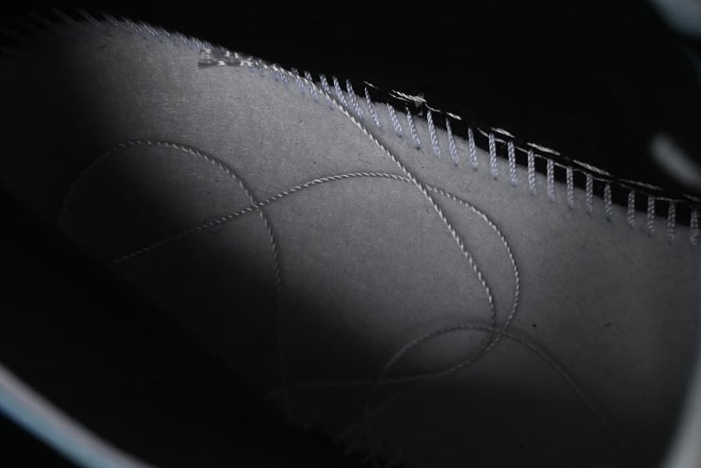 Close-up of stitched interior shoe panels