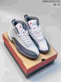 Pair of white and grey Air Jordan 12 high-top shoes with red accents, shown on a shoe box
