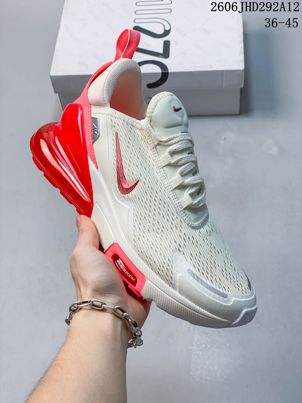 Angled side view of a white and red Nike Air Max 270 sneaker