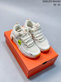 Pair of light-colored Nike Free Metcon 7 training shoes with orange outsole accents on an orange shoe box.