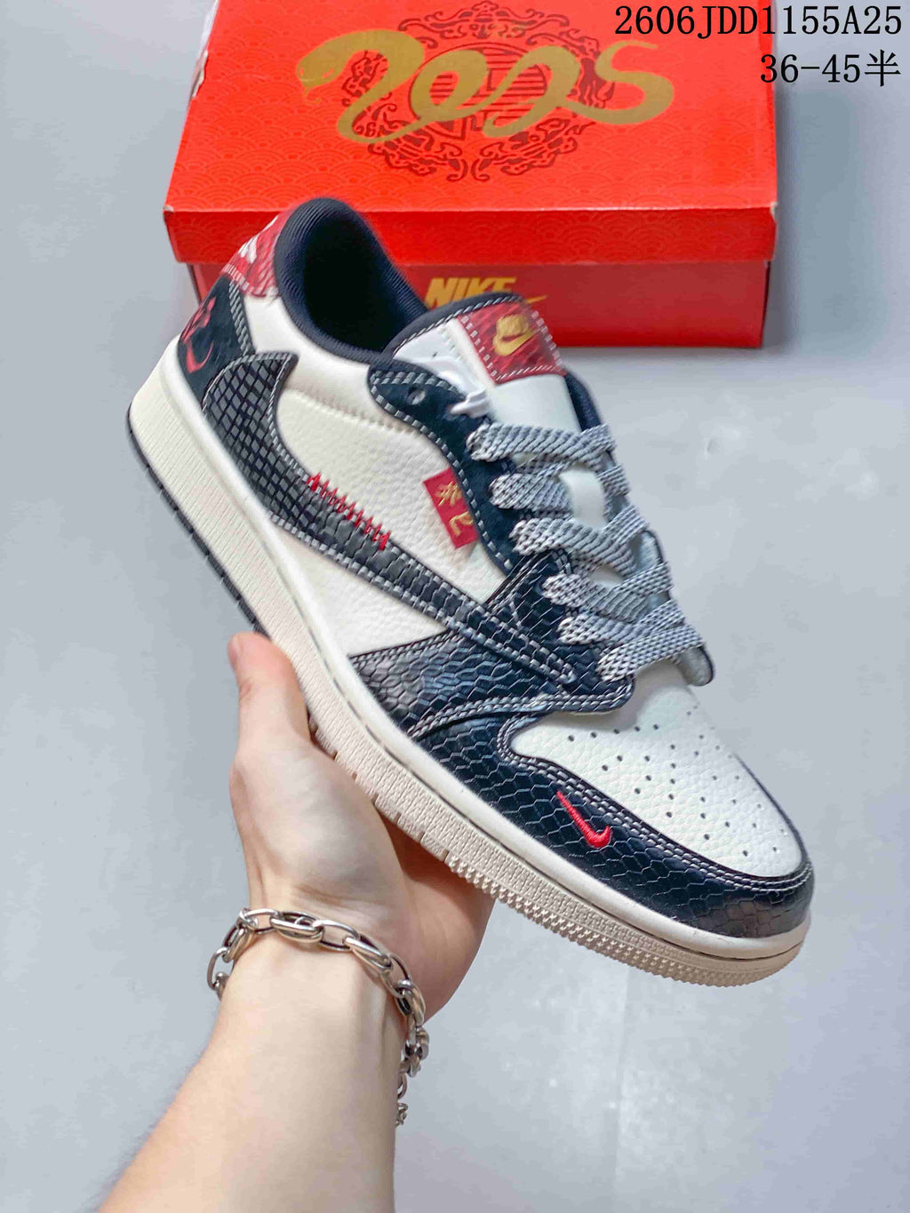 Angled side view of the sneaker showing its contrasting panels and red details