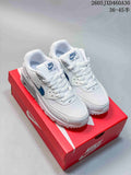 Pair of white Nike Air Max 90 sneakers with blue accents on a red shoe box