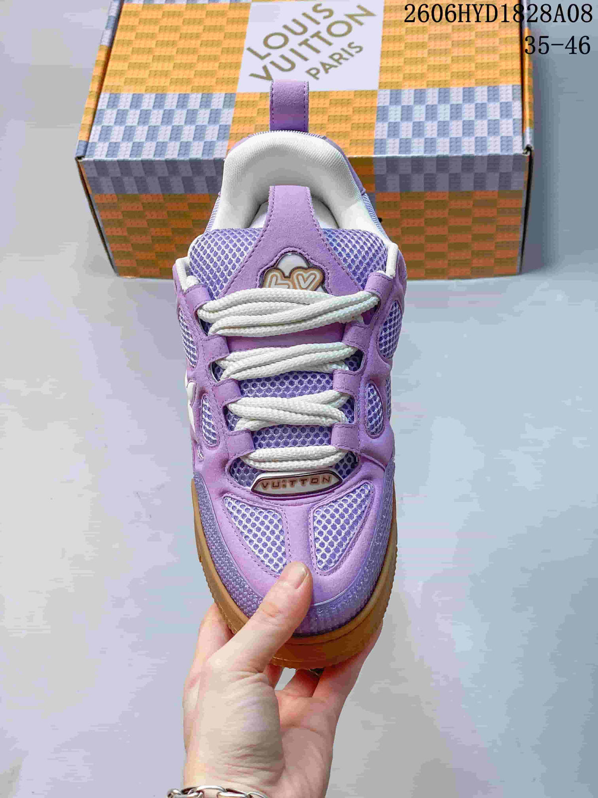 Top view of a lavender sneaker showing its mesh panels and white laces