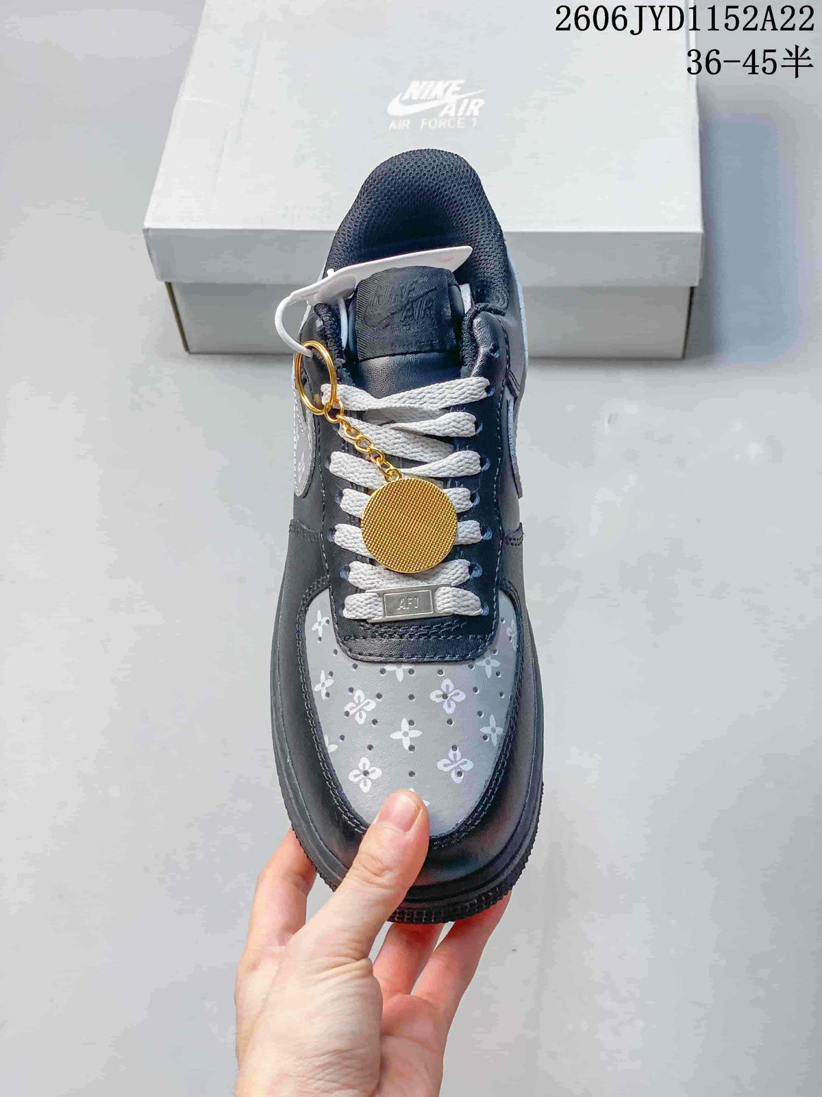 Top view showing floral toe panels, white laces, and a gold-tone charm