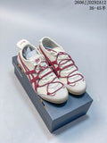 Pair of cream and burgundy Onitsuka Tiger Mexico 66 Deluxe sneakers on a shoebox
