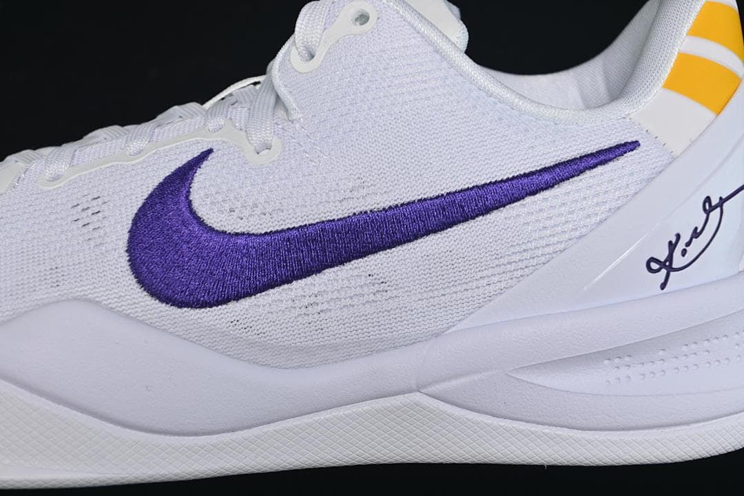Close-up of purple side Swoosh, white upper and Kobe signature