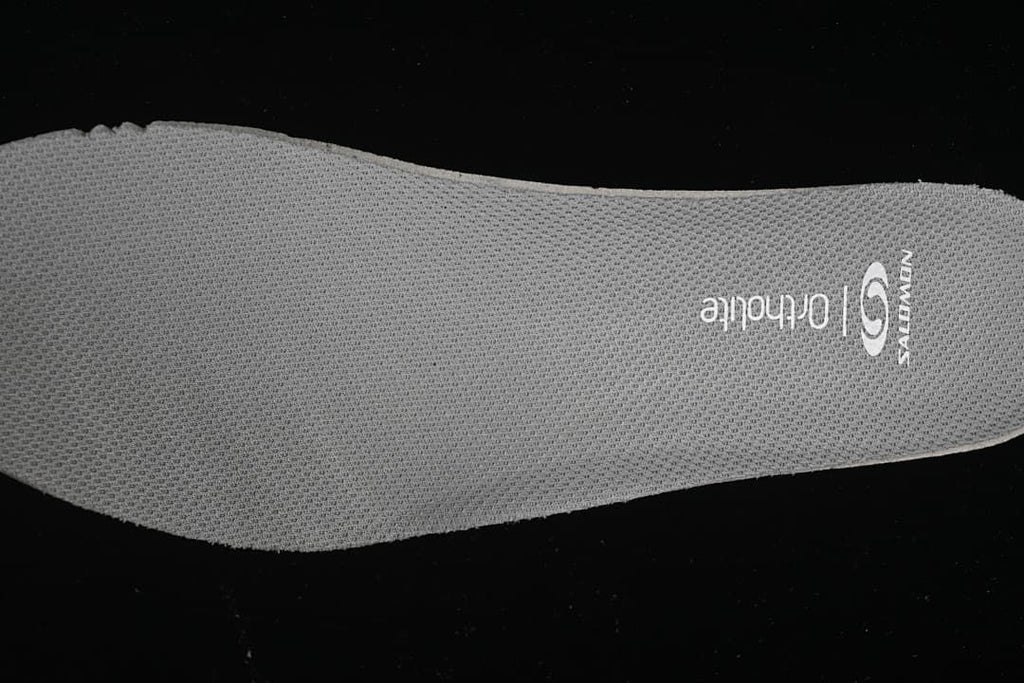 Close-up of a gray mesh insole with printed branding