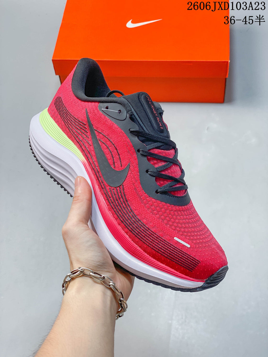 Side view of a red Nike running shoe with black accents and a ridged midsole.