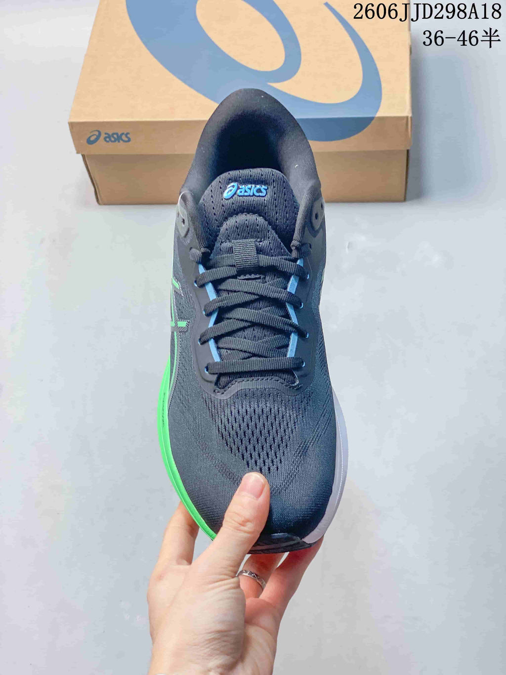Top view of a navy ASICS running shoe showing the lace-up front and mesh-like upper.