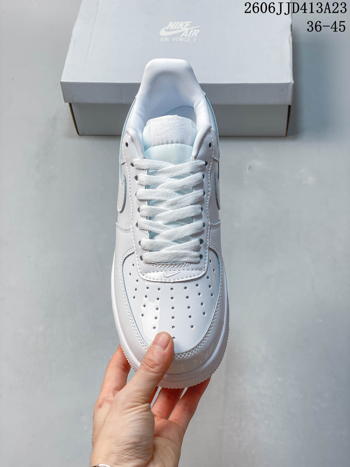 Top view of the white sneaker showing laces and perforated toe box