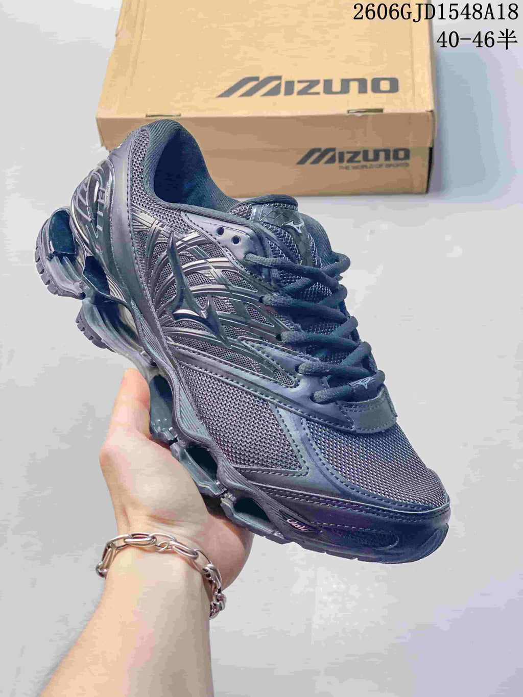 Dark navy Mizuno Prophecy 8 mesh running shoe held in front of a Mizuno box