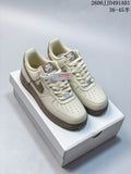Pair of cream and taupe Nike Air Force 1 '07 Low sneakers on a box