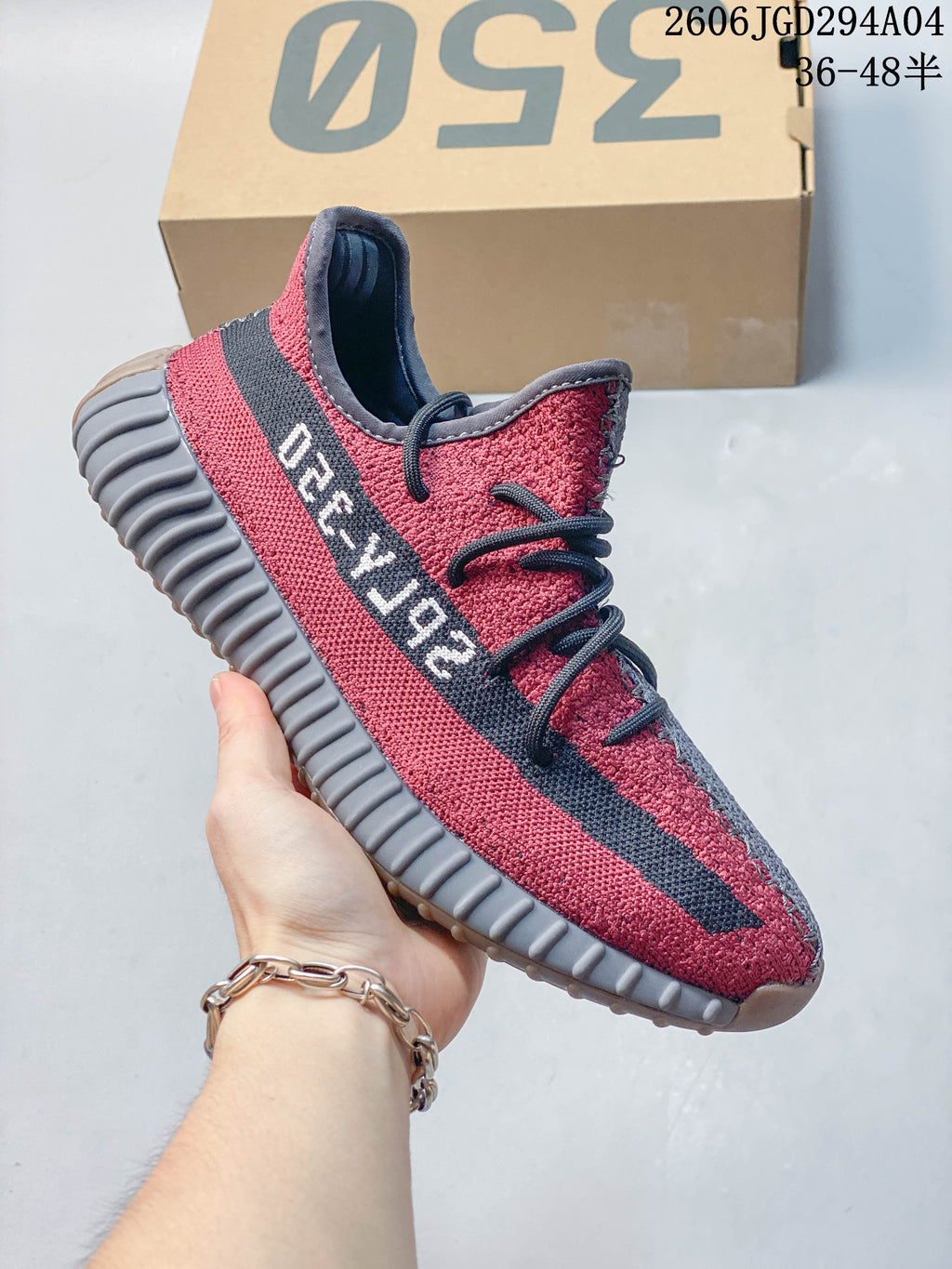 Bright red knit-look low-top sneaker with a black side stripe and dark ribbed sole.