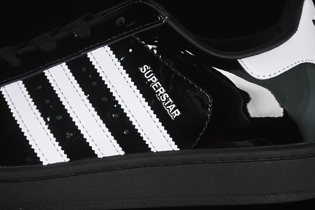 Close-up of the black upper, white stripes and Superstar lettering