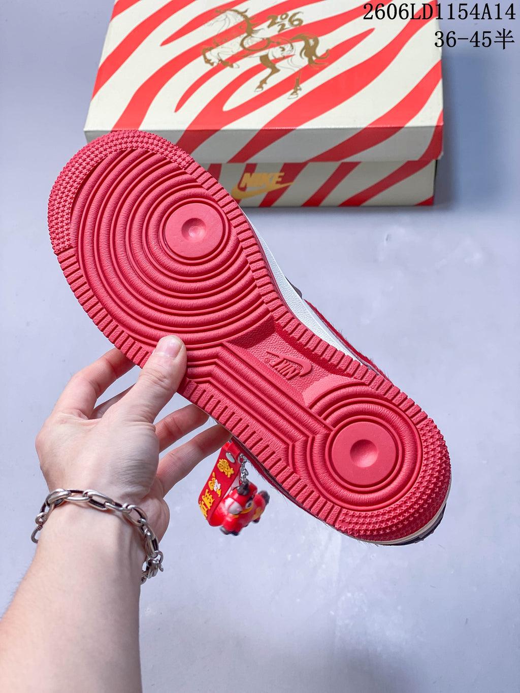 Close-up of the red outsole with circular tread details.