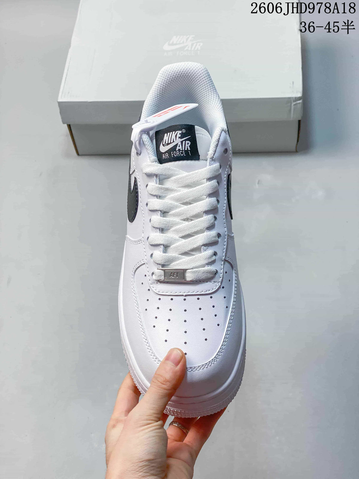 Top view of a white Nike Air Force 1 sneaker showing its laces and perforated toe
