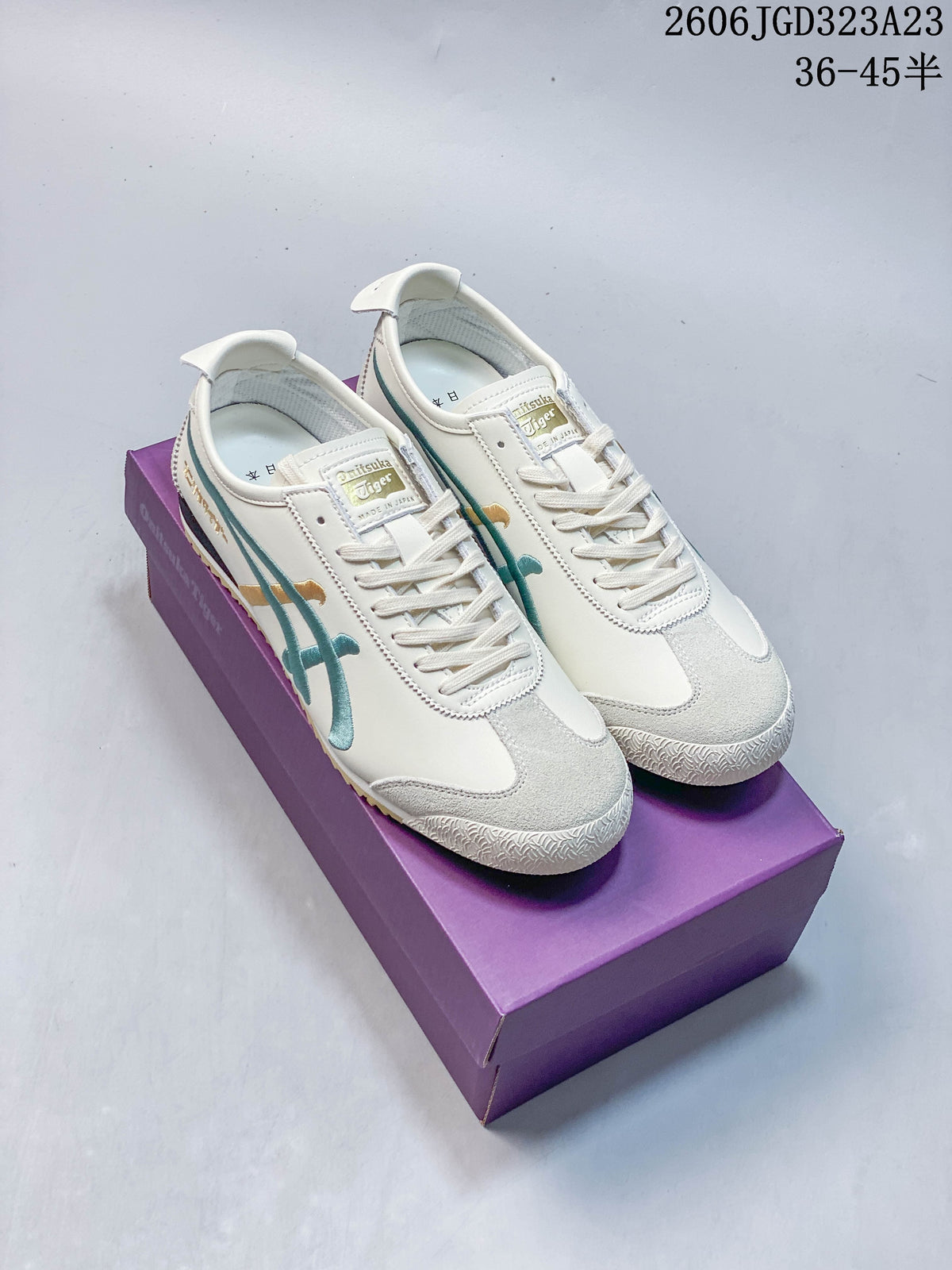 Ivory Onitsuka Tiger Mexico 66 NM low-top sneakers with teal and gold side stripes, shown on a purple box.