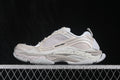 Side profile of cream and white Balenciaga Triple S 2 sneakers showing layered panels, mesh sections and a chunky outsole.