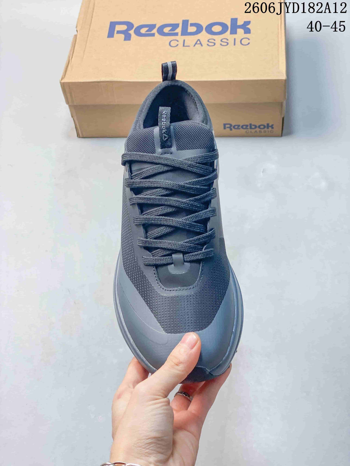 Top view of the grey sneaker showing its tongue and lace-up front