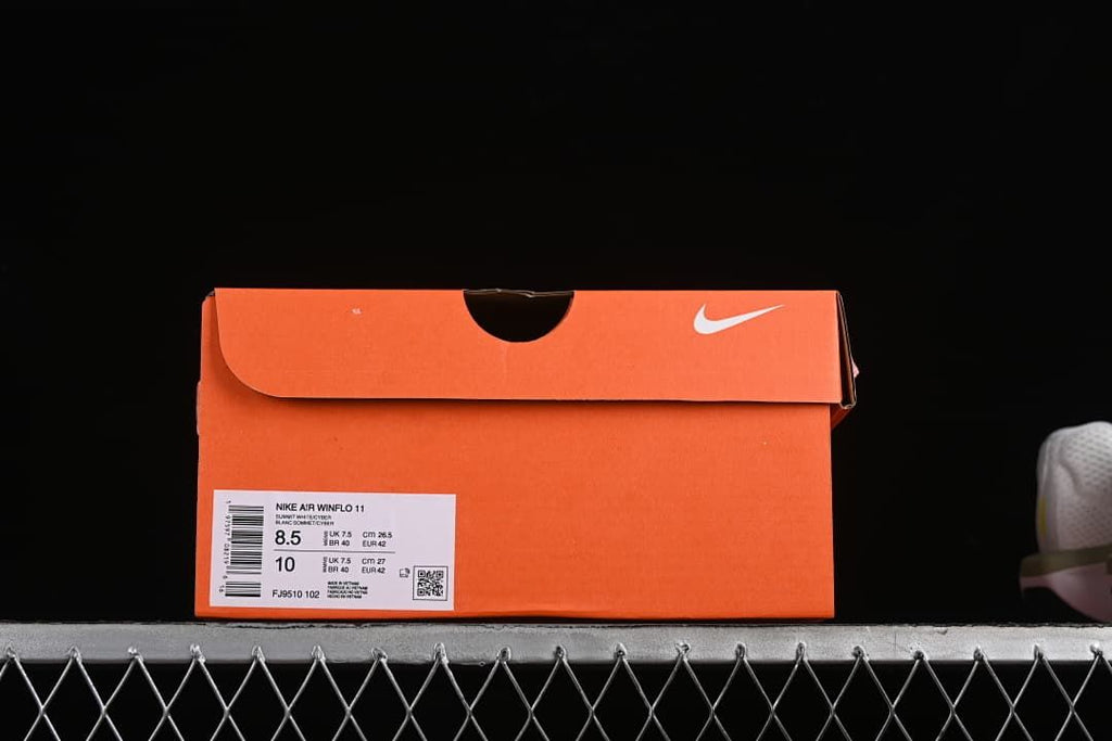 Orange shoe box with a visible Nike Air Winflo 11 label and style code FJ9510-102.