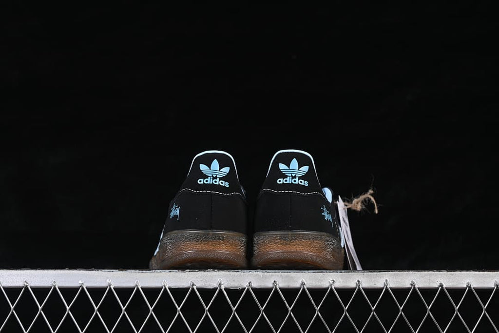 Rear view of both sneakers with light blue heel logos