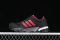 Side view of black Adidas AC8592 sneakers with red stripes and a white-dotted midsole.