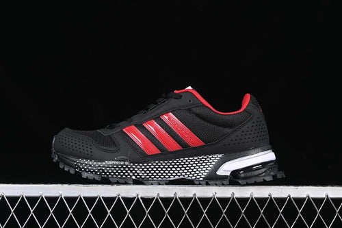 Side view of black Adidas AC8592 sneakers with red stripes and a white-dotted midsole.