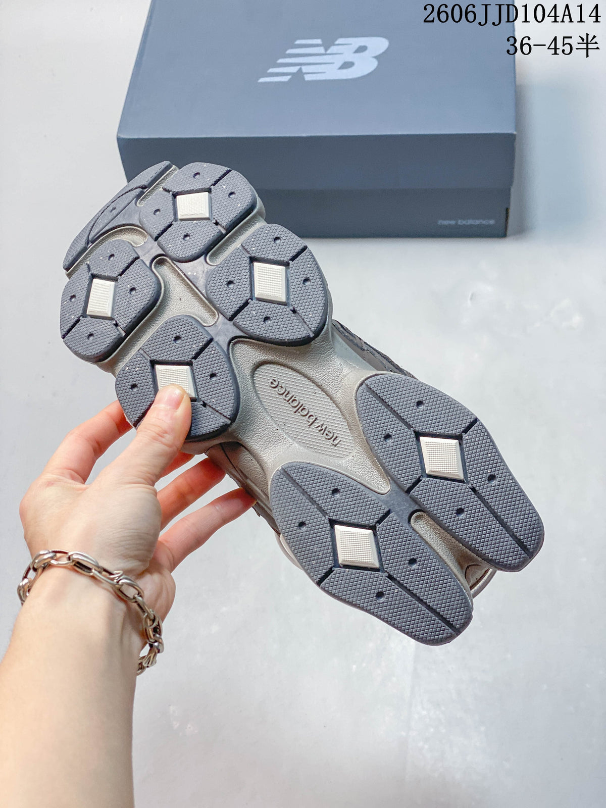 Underside of a New Balance 9060 sneaker showing its segmented grey outsole.