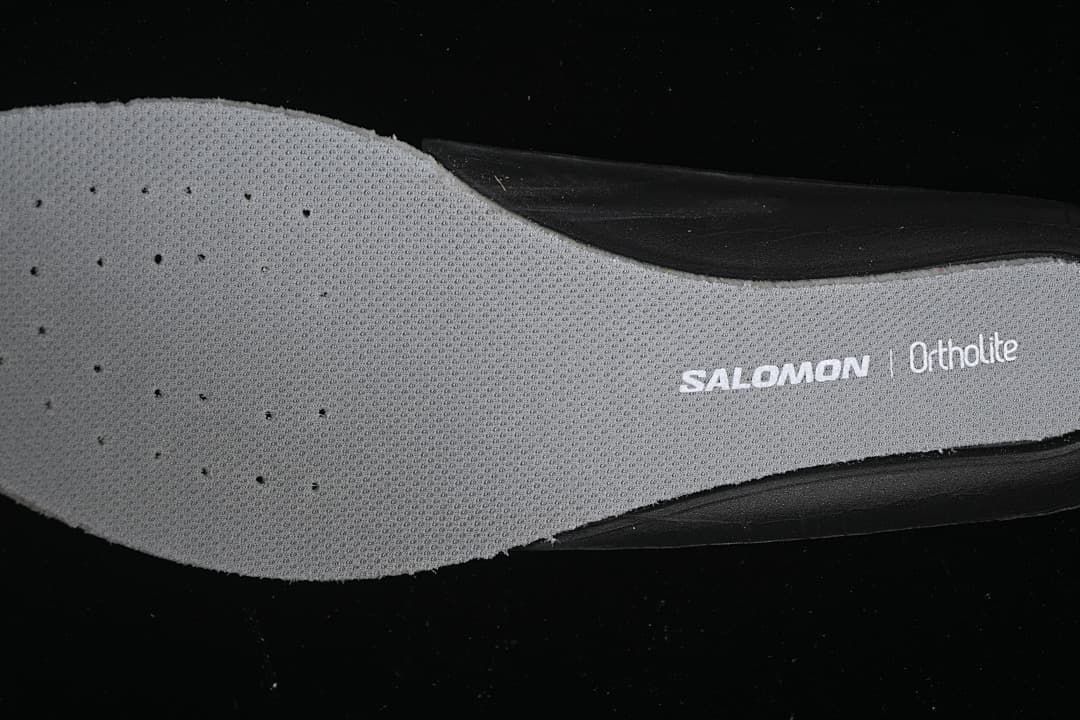 Close-up of a gray insole printed with Salomon and Ortholite branding.