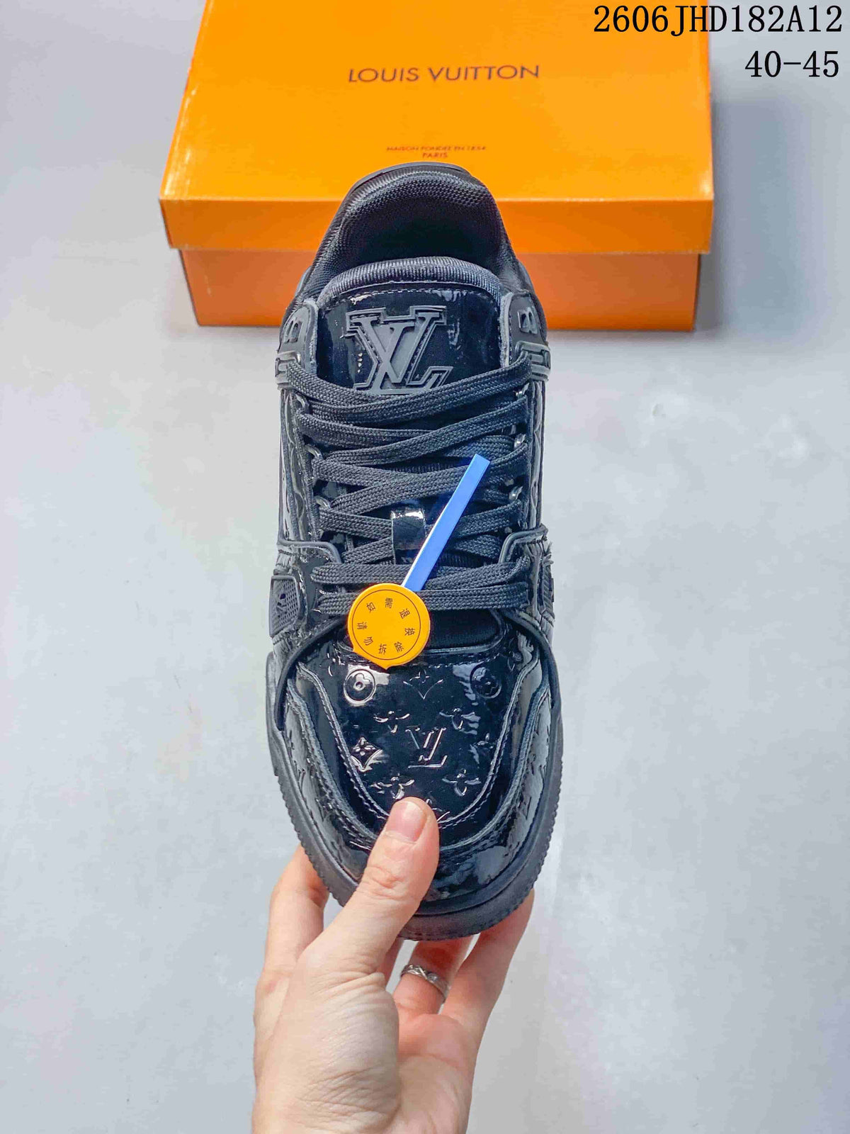 Top view of a dark navy Louis Vuitton Trainer sneaker with lace-up fastening