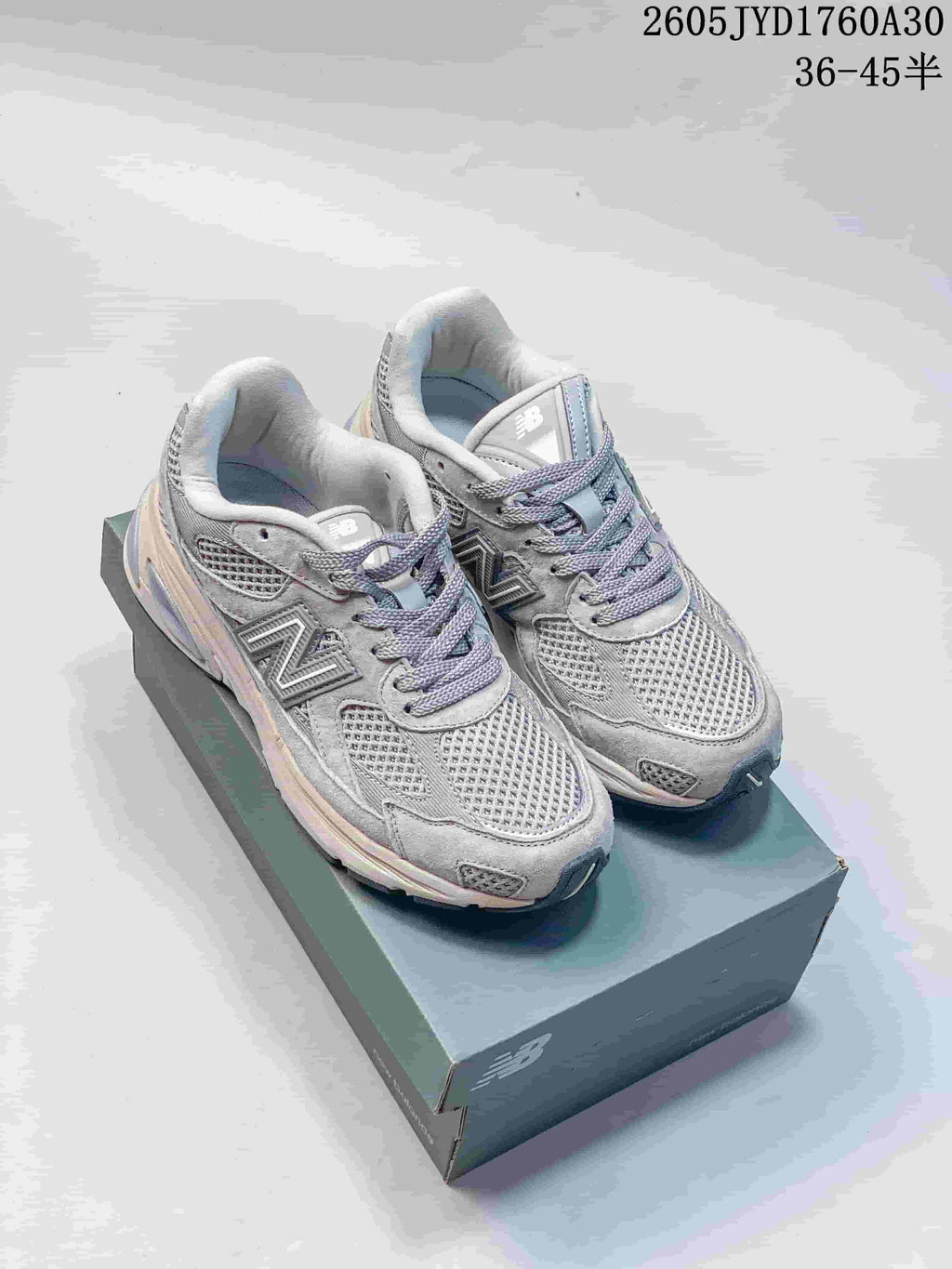 Pair of grey New Balance 2010 sneakers displayed on a shoebox