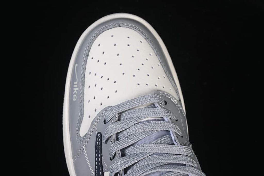 Top view of the perforated off-white toe box and gray laces.